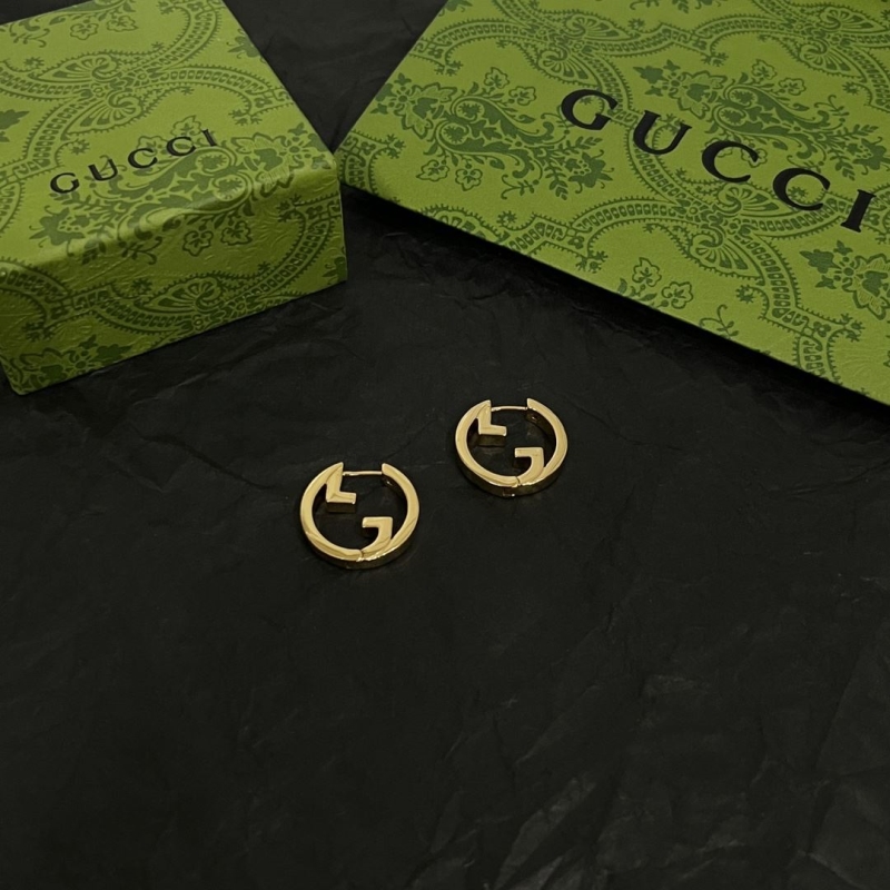 G*u*i earrings
